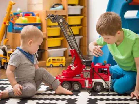 a couple of kids playing with a toy truck