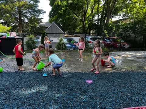 a group of children playing in a yard