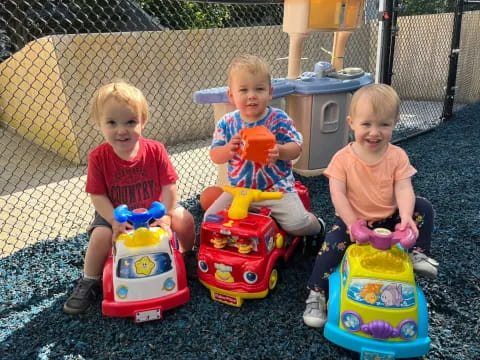 a group of kids sitting on toys