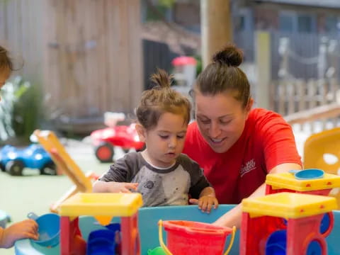 a person and a child playing with toys