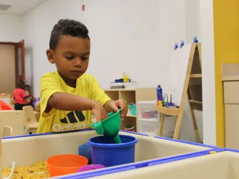 a young boy playing with a toy