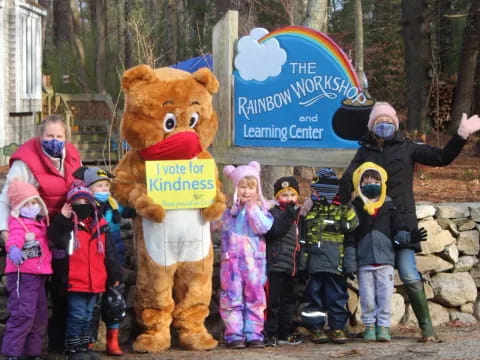 a group of people standing next to a person in a bear garment