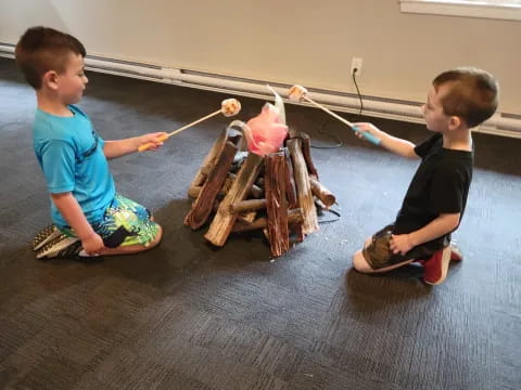 two boys playing with a toy