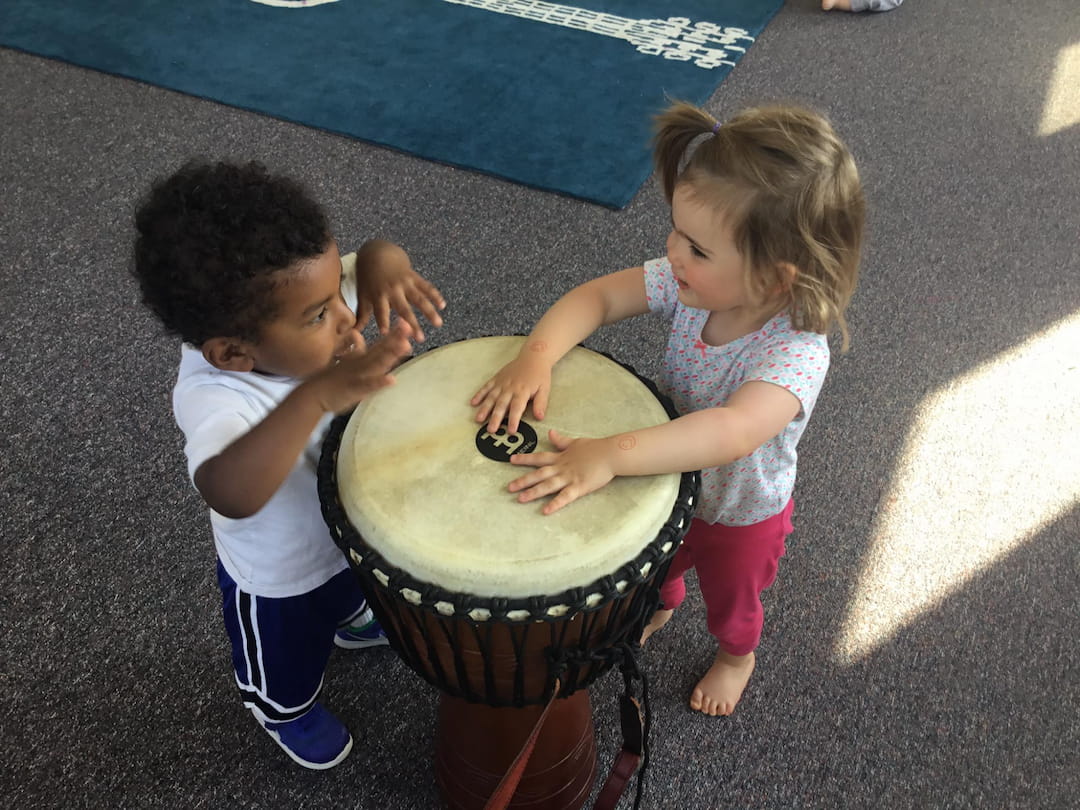 a couple of children playing with a toy