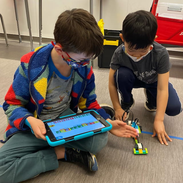 a few boys playing with a toy