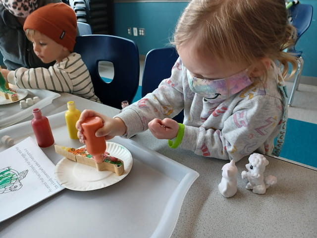 a little girl eating a cake