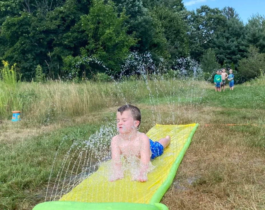 a boy sitting on a pool