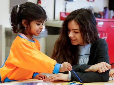 a person and a girl studying