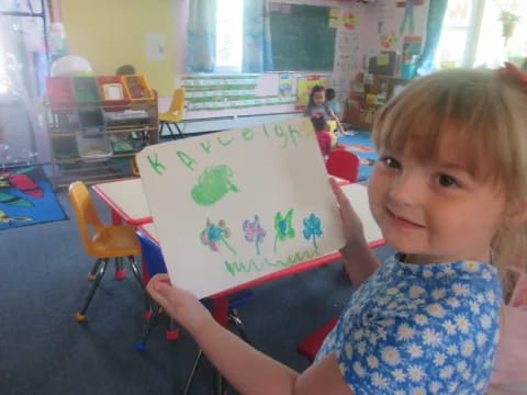 a child holding a drawing