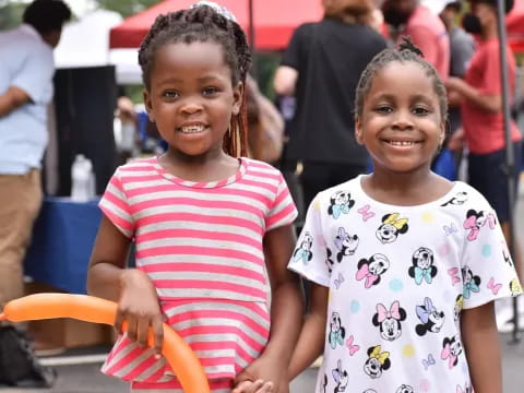 a couple of young girls smiling