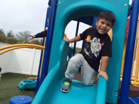 a boy on a playground slide