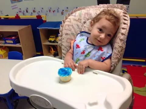 a baby eating a cupcake