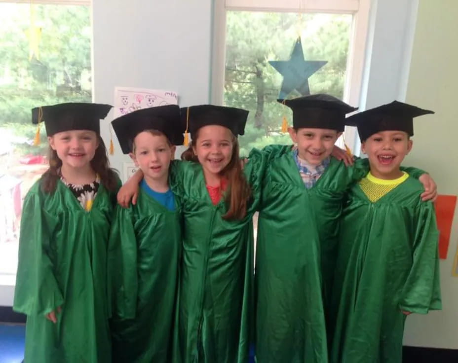 a group of children wearing graduation gowns and caps