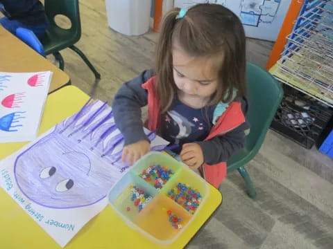 a girl sitting at a table