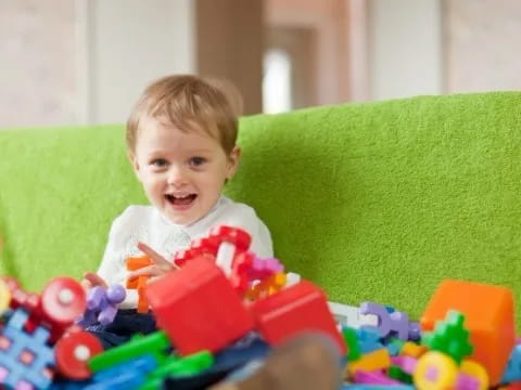 a baby sitting on a couch