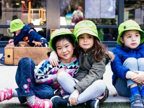 a group of children sitting on a bench