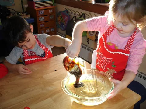 a couple of kids playing with a cake