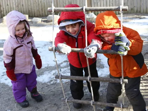 a group of children holding a snowman