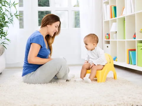 a person and a baby sitting on the floor