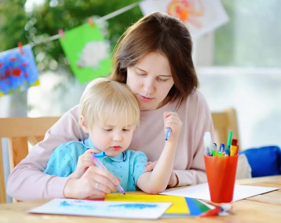 a person and a child sitting at a table