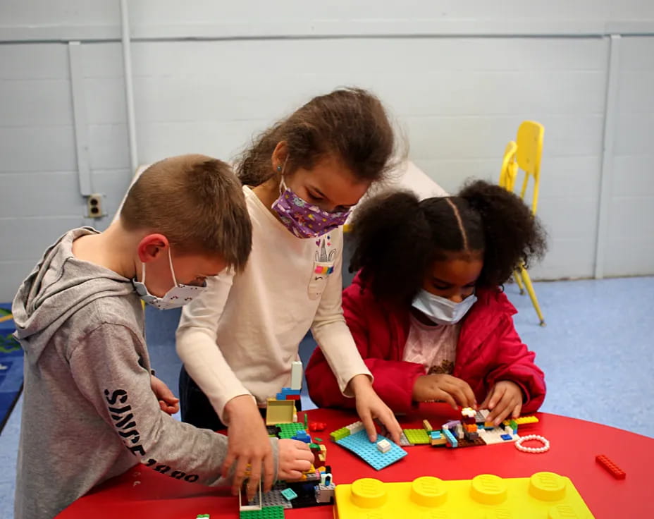 a group of people playing with toys