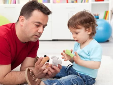 a person and a child playing with toys