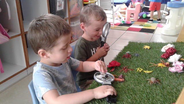 two boys sitting on the floor