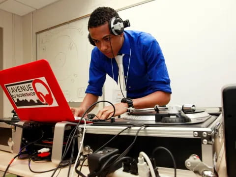 a man wearing headphones and working on a computer