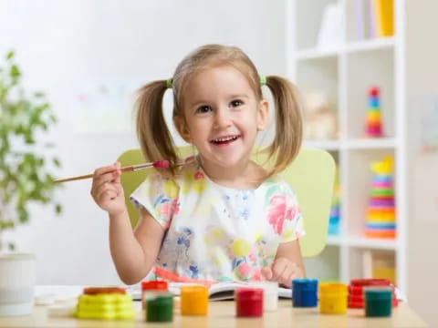 a girl painting with a brush