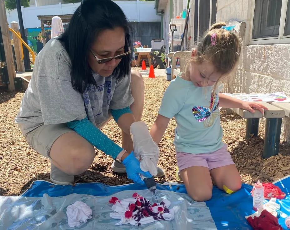 a woman and a child painting