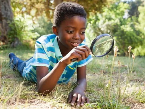 a young boy playing with a tennis racket