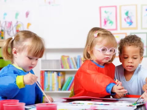 a group of children sitting at a table