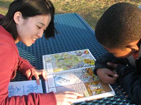 a person and a boy looking at a map
