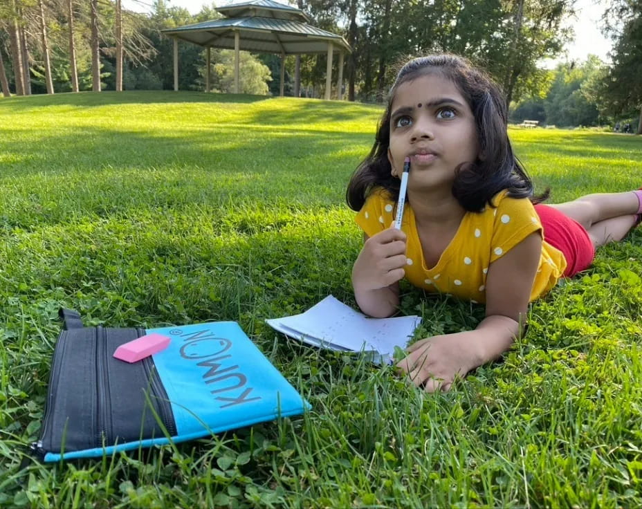 a girl sitting in the grass