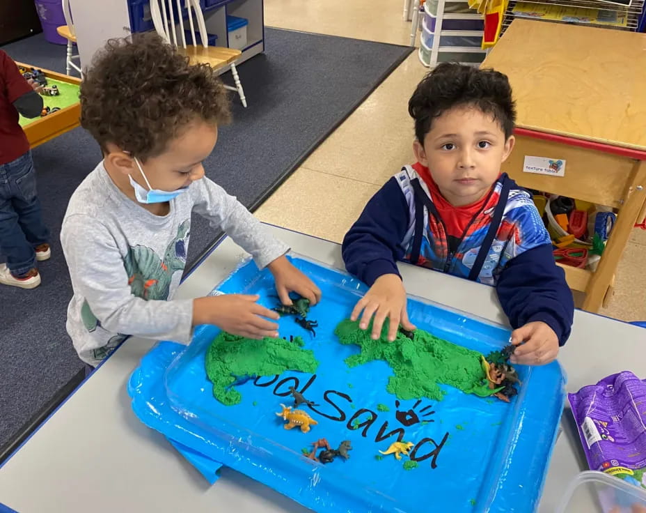 a couple of boys playing with a toy