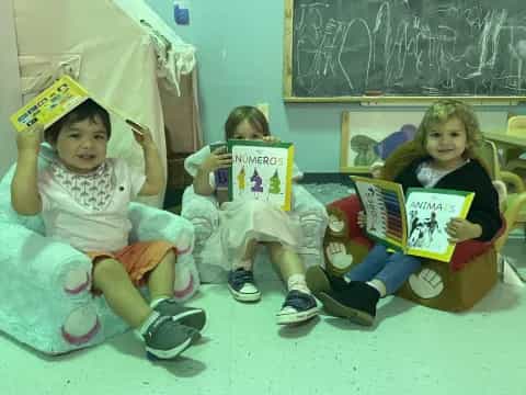 a group of children holding books