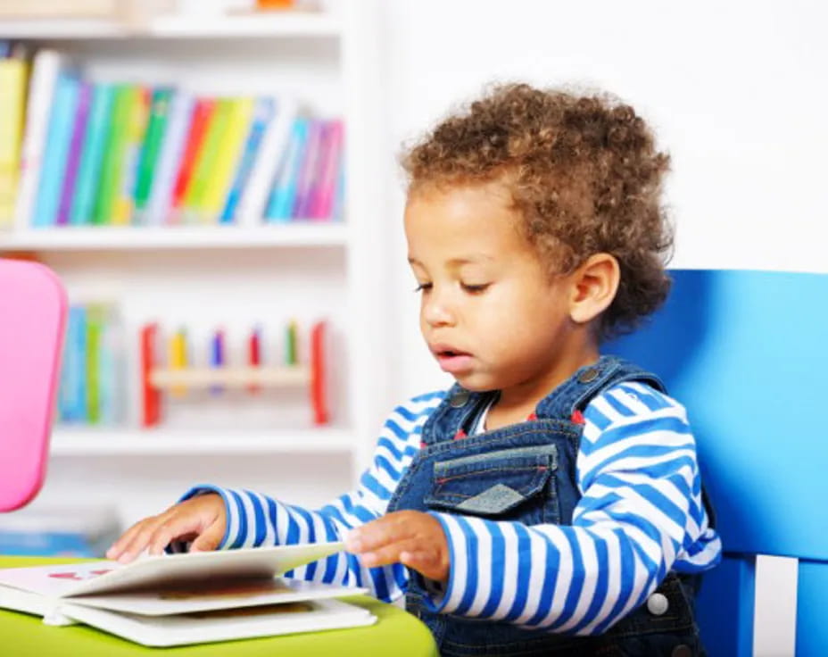 a young boy reading a book