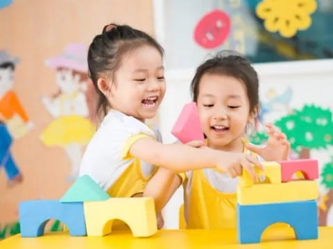 a couple of young girls playing with toys