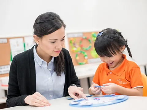 a person and a child looking at a paper