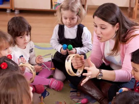 a person and several children sitting on the floor