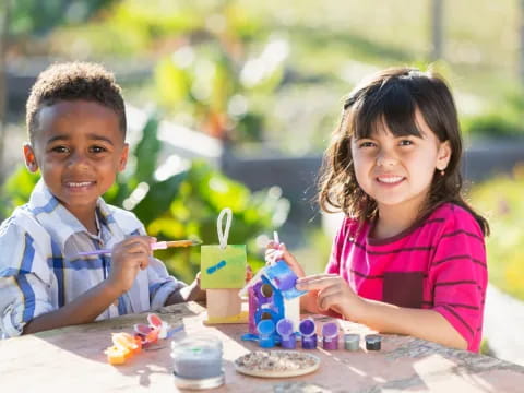 a boy and girl playing with building blocks