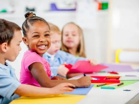 a few children sitting at a table