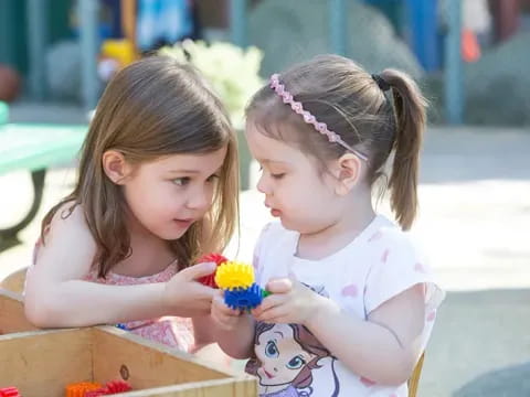 a couple of young girls holding flowers