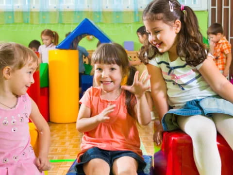 a group of children sitting on a play set