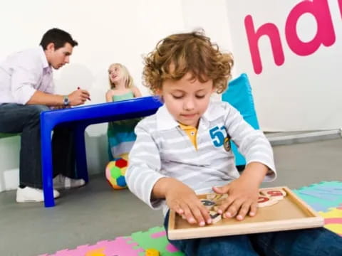 a young girl sitting on the floor