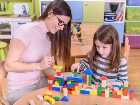 a woman and a girl playing with toys