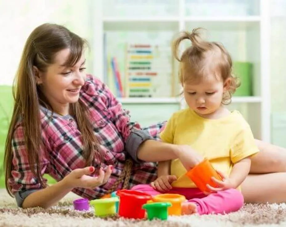 a person and a child playing with toys