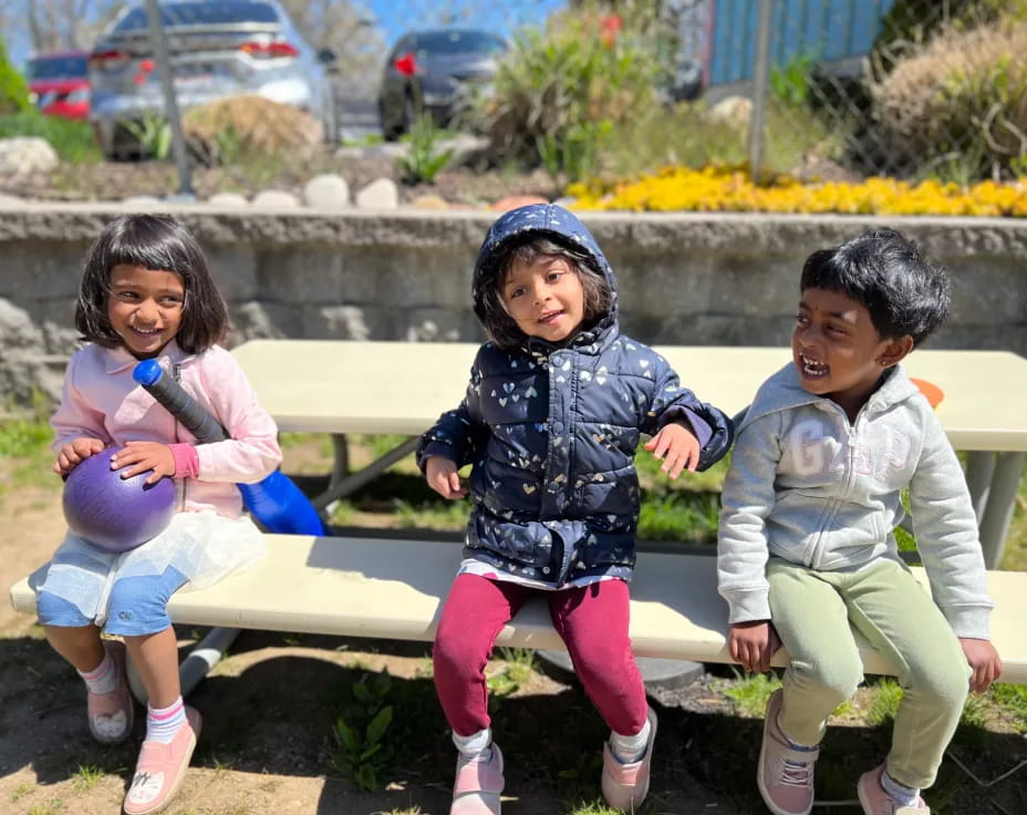 a group of children sitting on a bench