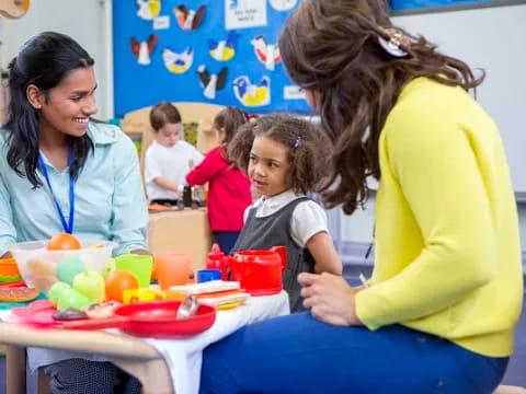 a woman and a child sitting at a table with a child