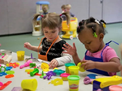 a few young girls playing with toys